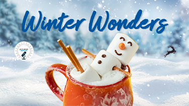 A marshmallow snowman uses a mug of hot cocoa as a hot tub in a snowy winter scene.