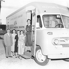 Bookmobile with Library Board members Ira Bales (first Chairman), Mrs. Mark (Kay) Robeson, Mrs. Orville (Dorothy) Hoff, Mrs. Irven (Dorothy) Snyder, and Miss Shirley Brother (first County Librarian)