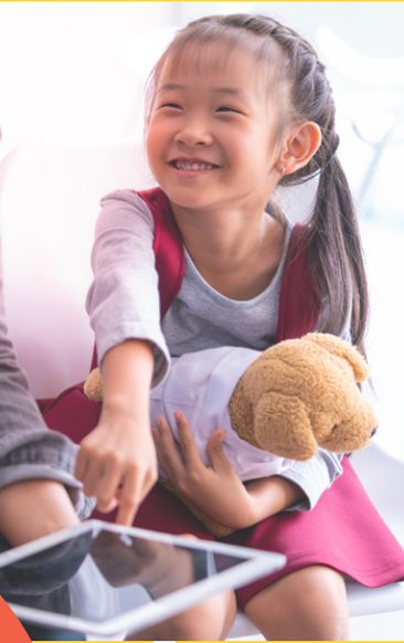 Photo of a young girl pointing to a tablet. 