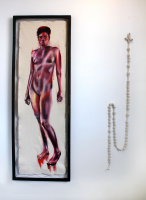 Exhibit of a knotted rope hung next to framed painting of a nude woman