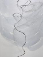 Zoomed in view of drawing of curved and looped string on a background of washed out gray.