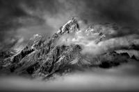 Black and White photograph of the Grand Tetons with cloud cover at the summit.