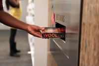 A picture of someone returning a book through the book return at Central Resource Library.
