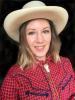 Blond woman in a red checkered shirt with a tan cowboy hat