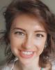 Molly Hopkins smiling woman with short, wavy brown hair